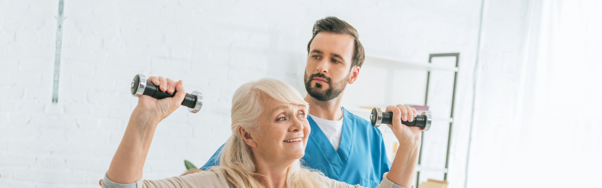 nurse helping senior with exercise