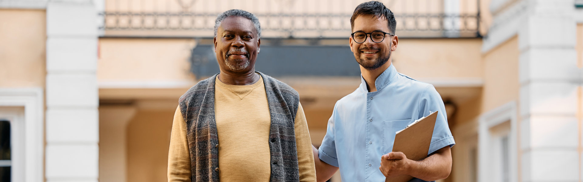 senior man and man holding a clipboard