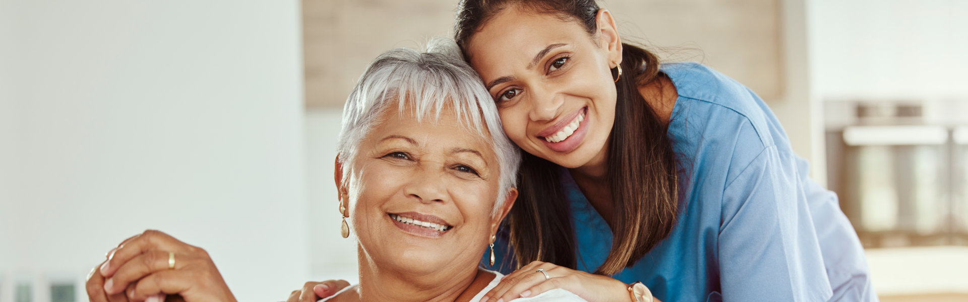 carer and senior woman smiling