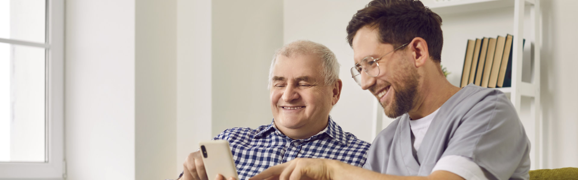 carer assisting an elderly man