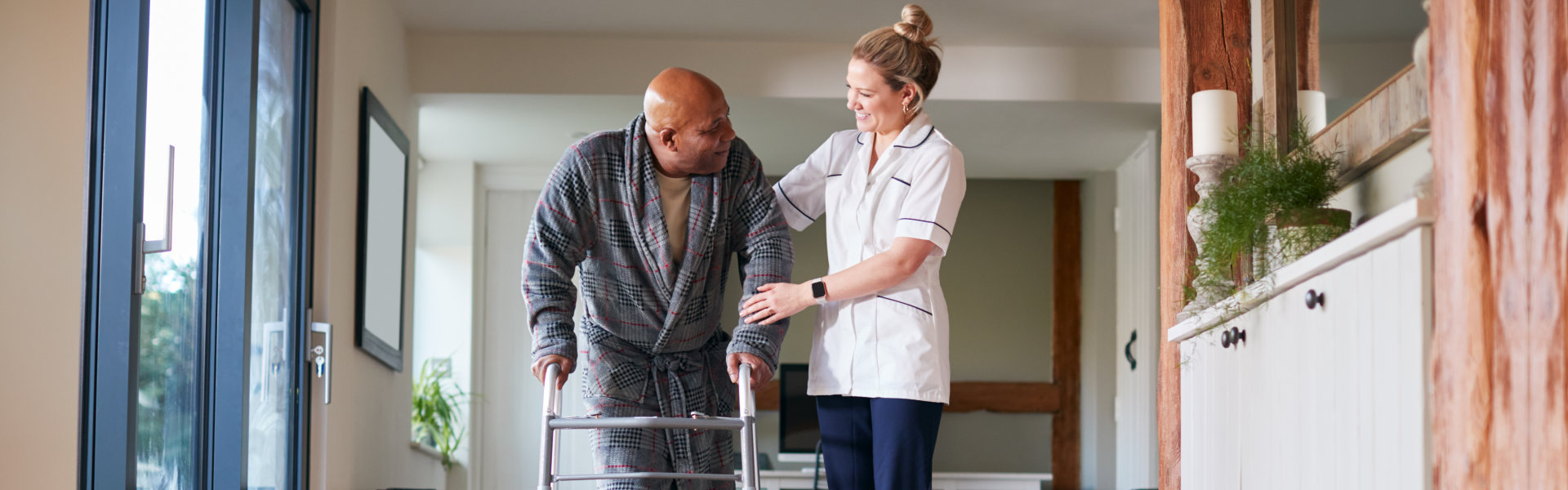 nurse helping senior walk